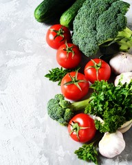 Fresh vegetables: tomatoes, broccoli, cucumbers and garlic. Healthy eating concept. Copy space