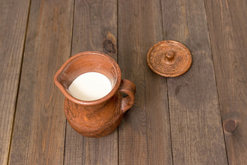 Fototapeta na wymiar Milk in a clay jug.