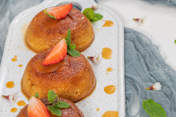 Caramel custard pudding  on plate over modern background with copy space.