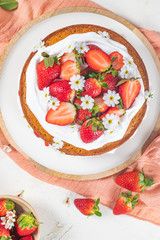 Strawberry cake, strawberry sponge cake with fresh strawberries and sour cream on a white background