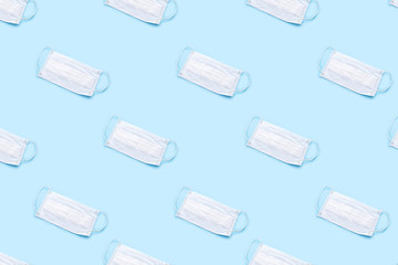 Disposable medical mask on blue background. Healthcare and medical concept.