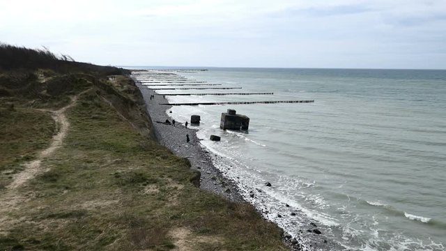 Baltic sea beach with old bunker of second world war. Cliff of Ahrenshoop on Darss peninsula in Germany.