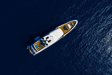 Aerial drone top down photo of Luxury Yacht boat near the famous island of Capri, Italy.