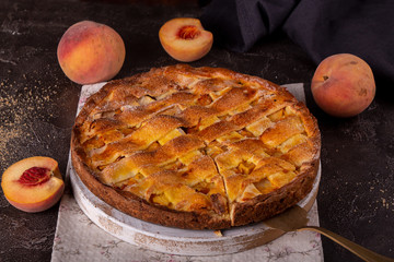 Homemade sweet pie cake with pear on black background.