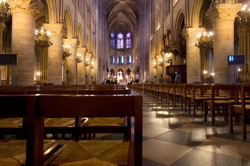 Fototapeta na wymiar Paris, Ile de la Cite, France - Empty chairs at the interior of Notre Dame Cathedral.