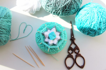 Wicker mandala made of blue yarn on wooden toothpicks. Flower pattern.