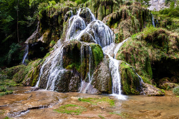Waterfall Cascade des Tufs in Jura Mountains area. Characteristic unique waterfall. France, Europe.