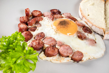 Fried egg with chopped sausage.