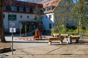 Fototapeta na wymiar Germany, Mannheim, 23.03.2020: Playground closed due due Corona virus crisis. German words „Parkanlage gesperrt“ means Playground is closed.