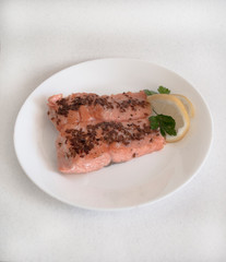 red trout fish on a white plate