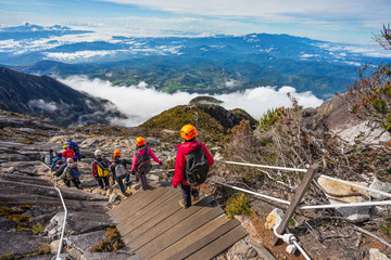 Trekkers walking down after summited Kinabalu mountain peak, Borneo island in Sabah, Malaysia