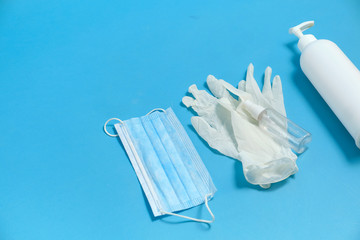 Mask, gloves and soap isolated on a blue background.