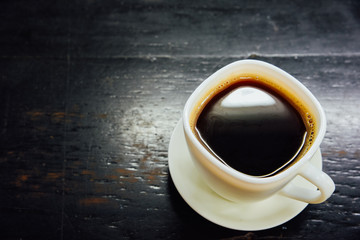 Espresso in a glass on black wooden table,Top view