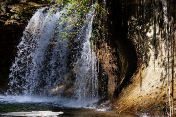 Waterfall at Herisson River in Jura Mountains area. Sunny weather day. France, Europe.