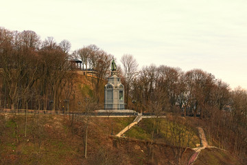 Picturesque landscape view of Saint Vladimir Hill (Vladimirskaya Gorka) with famous the Monument of Volodymyr The Great surrounded by trees without leaves. Early spring morning view. Kyiv, Ukraine