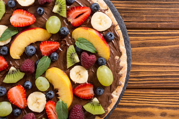 Fruit pizza with nut nougat cream , fruit and berries