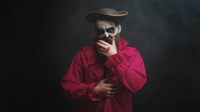 Man dressed up like a scary pirate in red shirt and with a hat