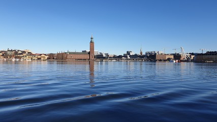 Fototapeta premium Panoramic view of the sea bay and the city against the blue sky. Spring Sweden