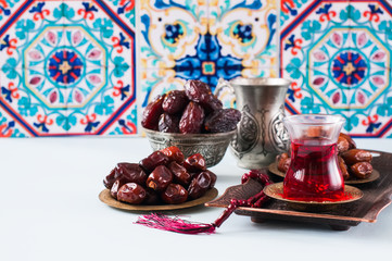Assorted dried dates or kurma in a vintage plates and tea