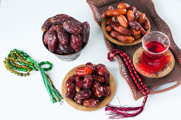 Assorted dried dates or kurma in a vintage plates and tea