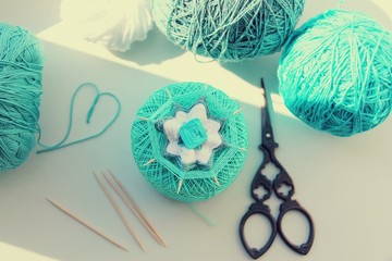 Wicker mandala made of blue yarn on wooden toothpicks. Flower pattern.