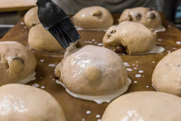 Preparing the chocolate buns to be baked