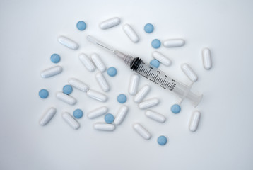 pills and syringe isolated on white background