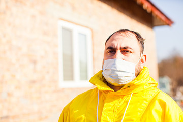 Worried man outdoors in protective medical mask