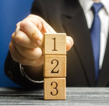 Businessman puts wooden blocks with the number 1 2 3. Task list. Alternate items and conditions for implementation. Contract road map. Organization and systematization, step by step instructions.