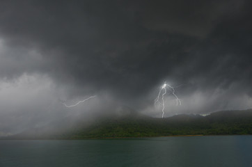 Rain and lightning over island and sea