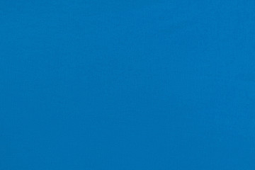 Blue homogeneous background with a textured surface, fabric.