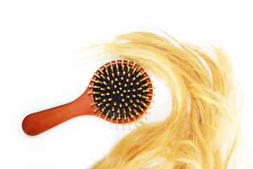 cut blonde tangled yellow hair and massage wooden comb