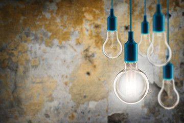 Leadership and idea creative concept - Vintage incandescent bulbs on the grunge background