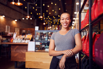 Fototapeta na wymiar Portrait Of Female Coffee Shop Owner Standing By Counter