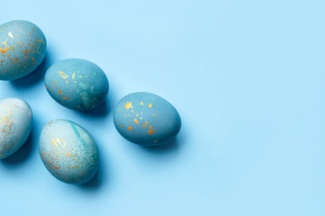Easter frame of eggs painted in blue color. Flat lay, top view.