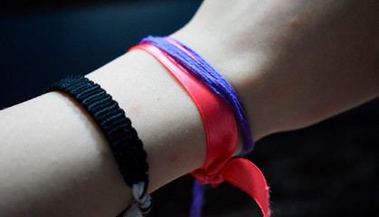 colored ribbons tied around the wrist