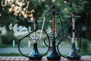 Stylish wooden hookah in the evening on a summer terrace in a cafe