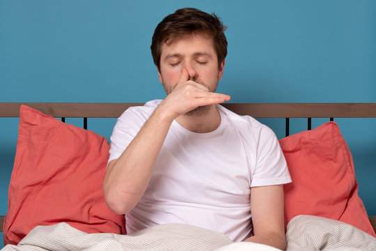 Man Breathing Alternate Nostril Breathing Exercise, Working Outsitting In Bed