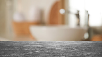 Empty table and blurred view of stylish bathroom interior