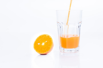 Orange juice and pieces of orange fruit isolated on a white background