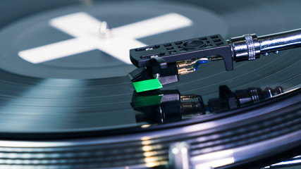 Close-up of modern turntable vinyl record player with music plate. Needle on a vinyl record