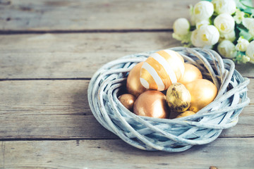 easter eggs colored with golden paint in differen patterns. Copy space.