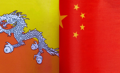 fragments of national flags of the Kingdom of Bhutan and China close up