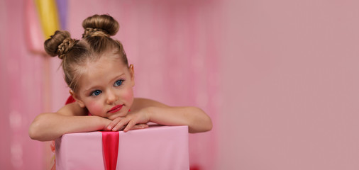 portrait of a girl-model, having fun at a birthday party in a beautiful, delicious, pink candy interior, the concept of themed children's holidays, participation in competitions. banner