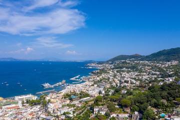Aerial Drone photo of the beautiful island of ischia with blue sea and skies with hundreds of boats in Ischia, Italy