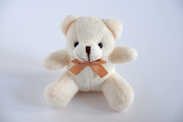 A soft beige bear is sitting there. Children's toy