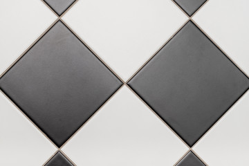 Bottom tiles in black and white laid out in diamond pattern