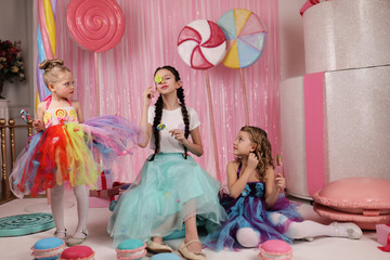 girls-models have fun at a birthday party in a beautiful, delicious, pink candy interior, the...