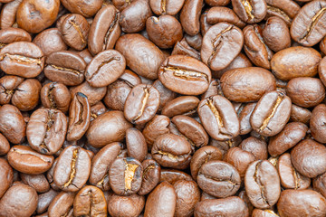 Coffee beans background texture of roasted seeds close up