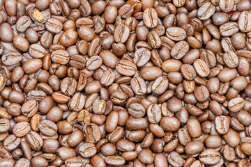 Dark coffee beans background texture of roasted seeds